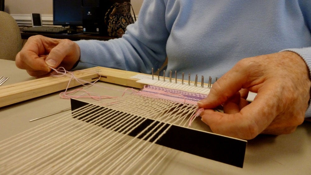 Close-up image of LLP weaving class instructor demonstrating a technique